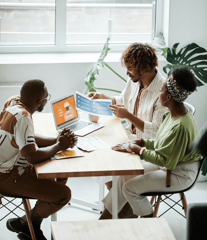 people seating around a computer