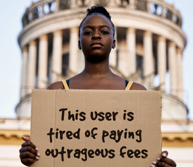 Woman holding placard that reads "This user is tired of paying outrageous fees"