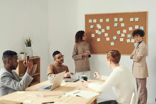 Women Standing beside Corkboard. Photo by fauxels on pexels.com
