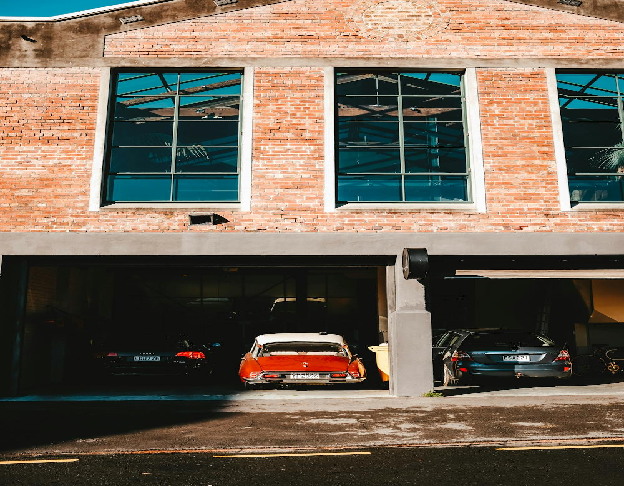 Two Red and Black Vehicles Parked in a garage. Photo by Adrien Olichon on pexels.com
