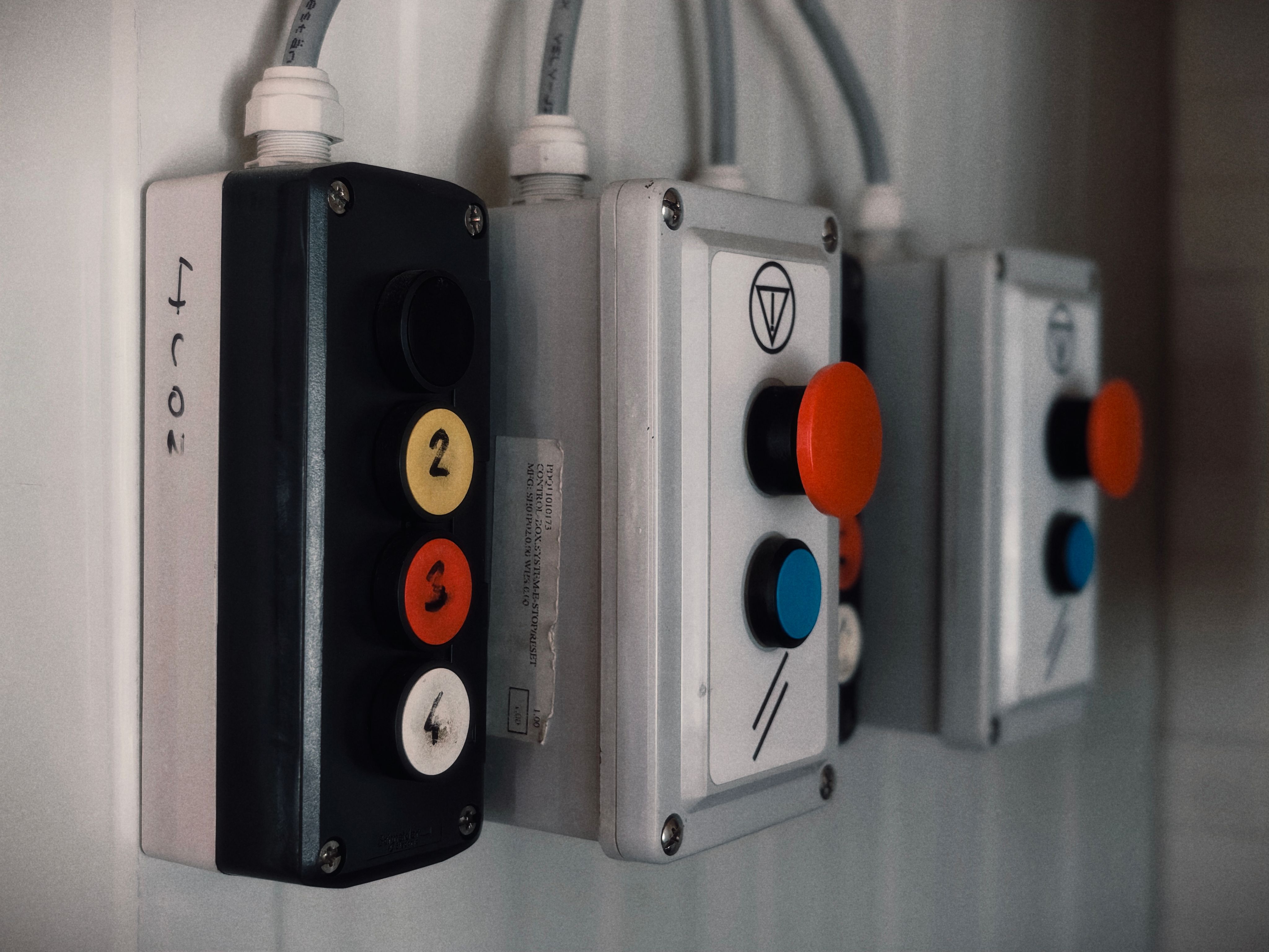 Close-up of industrial control panels featuring numbered and colored buttons. Photo by Kamil Čičila from pexels.com