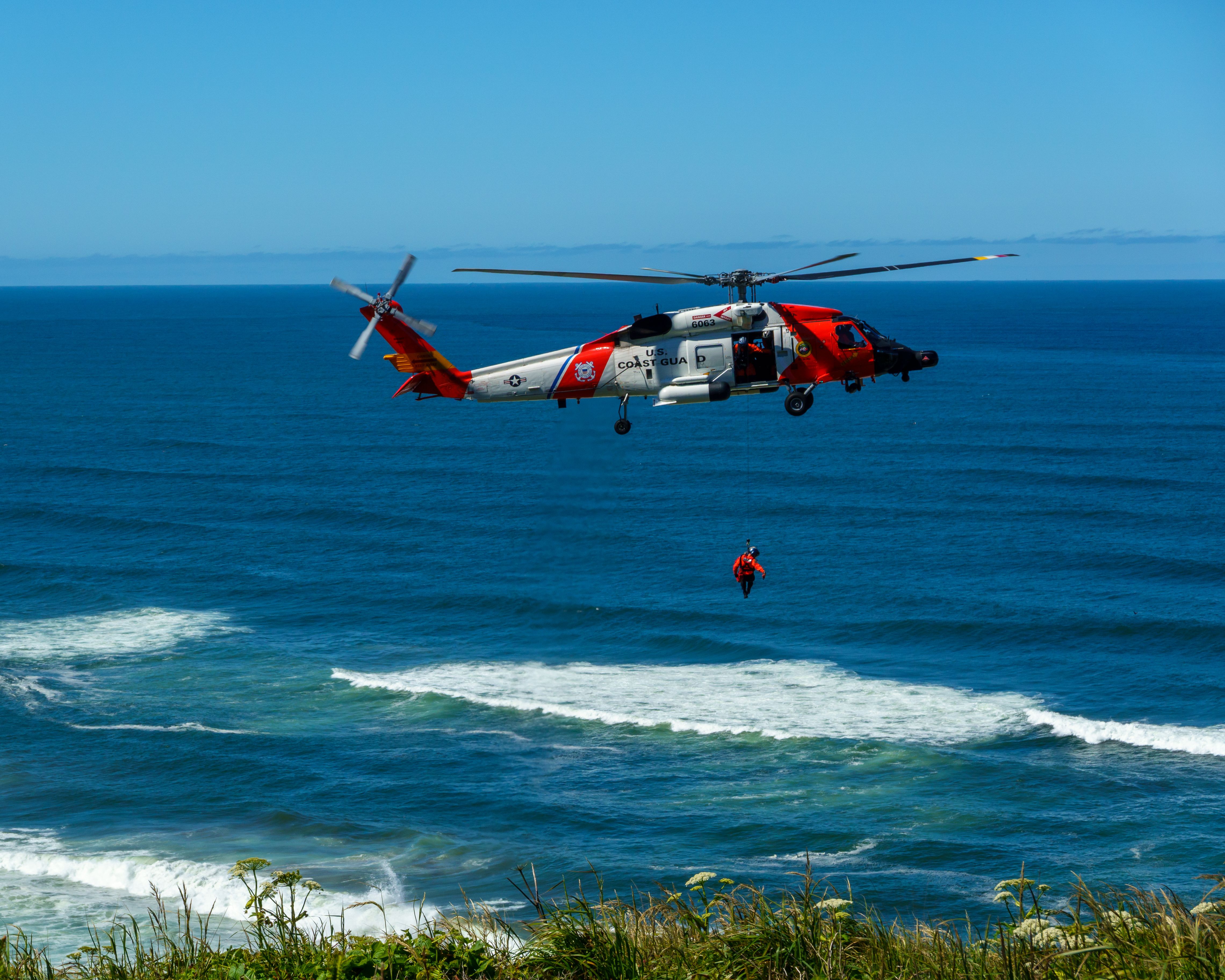 Dramatic coast guard helicopter rescue operation over the ocean waves. Photo by William Jacobs on pexels.com