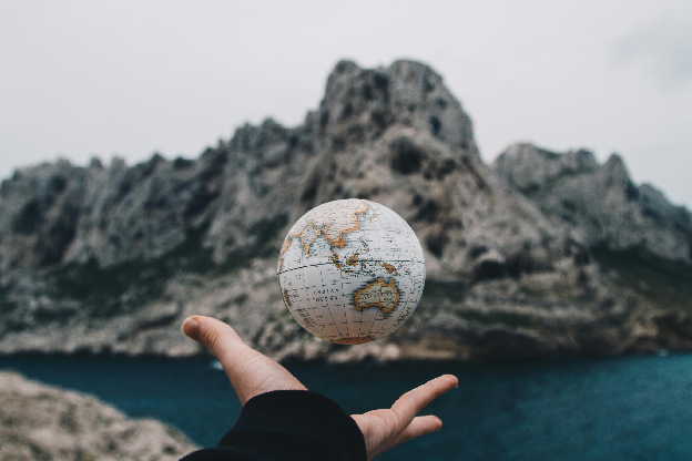 Person Tossing Globe. Photo by Valentin Antonucci on pexels.com