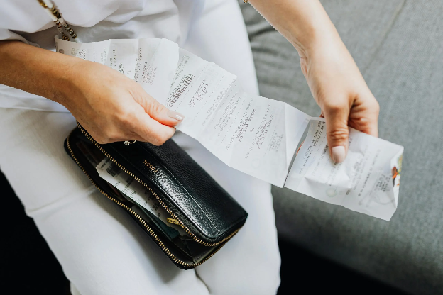 A Person Holding a Wallet and receipt. Photo by Kaboompics.com on pexels.com