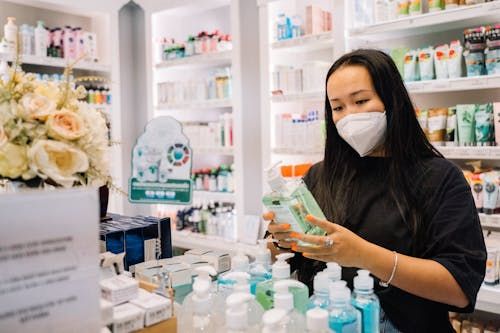 Woman in Black Shirt Holding A Hand Sanitizer Bottle. Photo by Anna Tarazevich on pexels.com