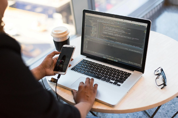 Woman working with her phone and laptop. Photo by Christina Morillo on pexels.com