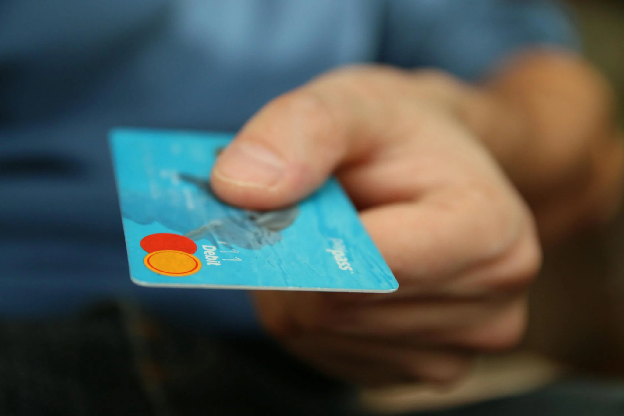 Person Holding Debit Card. Photo by pixabay on pexels.com